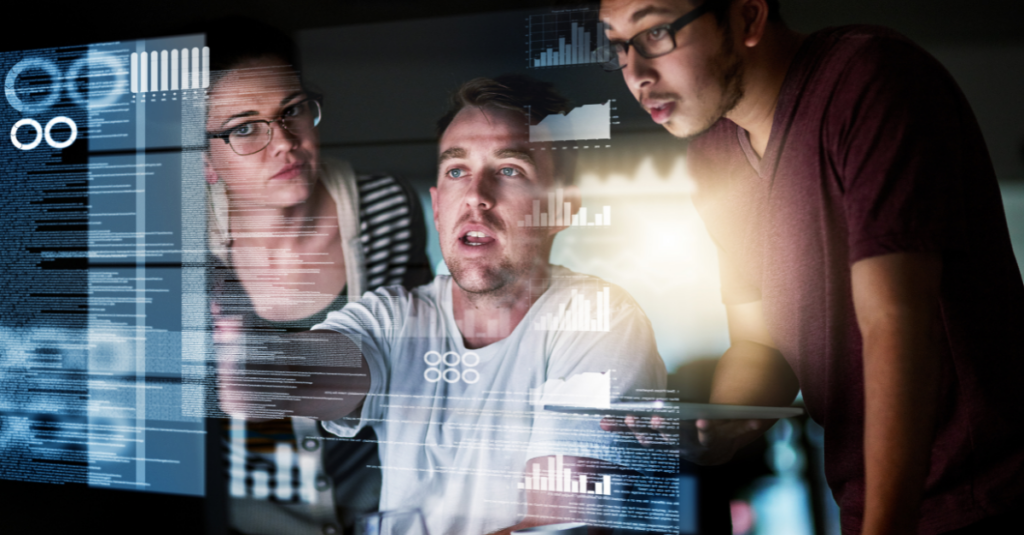 A team of professionals collaborating with digital dashboards displaying analytics and security metrics, showcasing technology-driven data protection.